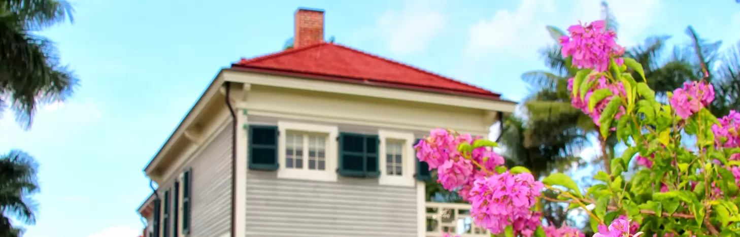 A white house with pink flowers in front of it at Edison & Ford Winter Estates